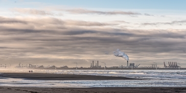 beautiful-shot-sea-with-windmills-factory-distance-cloudy-sky (1)